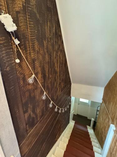 a staircase in a building with a wooden wall at Charmig villa med 3 sovrum i Ljungaverk in Ljungaverk