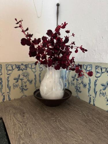 a vase with flowers in it sitting on a table at Charmig villa med 3 sovrum i Ljungaverk in Ljungaverk