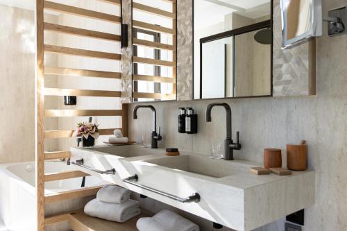 a bathroom with a sink and a mirror at Hotel Royal-Riviera in Saint-Jean-Cap-Ferrat