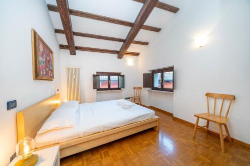 a bedroom with a bed and a table and a chair at Historic Elegance - Apt in the Heart of Udine in Udine