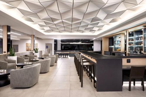 a rendering of a restaurant with a bar and chairs at AC Hotel by Marriott Pleasanton in Pleasanton
