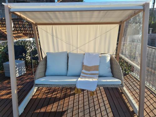 a gazebo with a couch on a deck at Terrace Douro in Vila Nova de Gaia