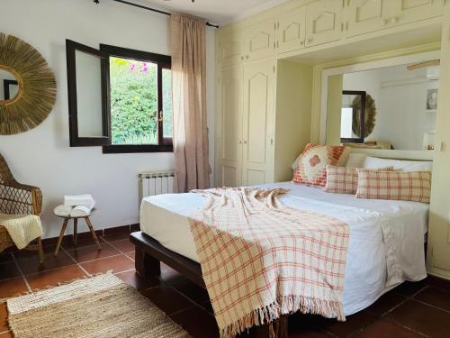 a bedroom with a large bed with a mirror at Gothia Villa Exclusiva Villa con Piscina Sauna in Illes Balears