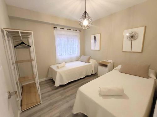 Posteľ alebo postele v izbe v ubytovaní Apartamento Mármoles - Centro Málaga