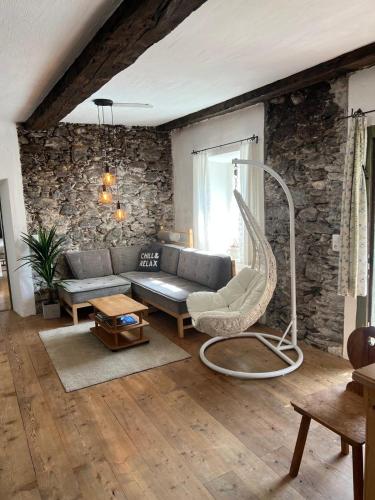 a living room with a couch and a chair at Mountain Resort in Rangersdorf
