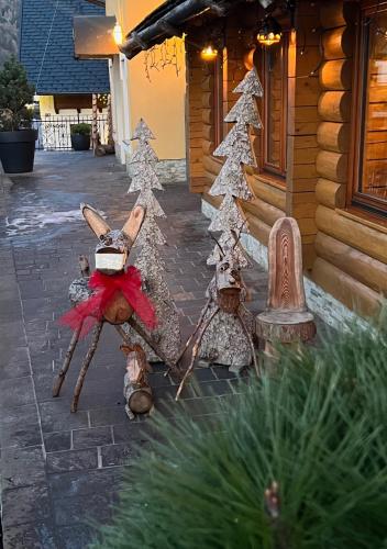 a group of christmas decorations in front of a house at Kotnik Superior Boutique Hotel in Kranjska Gora