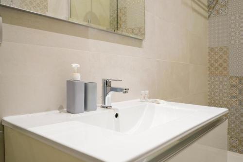 a bathroom with a white sink and a mirror at Mati's in Monopoli