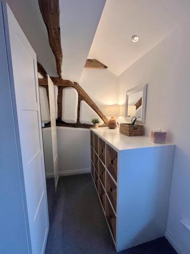 a bathroom with a vanity with a mirror and a tree at MC 2 bed central location - no parking in Stratford-upon-Avon