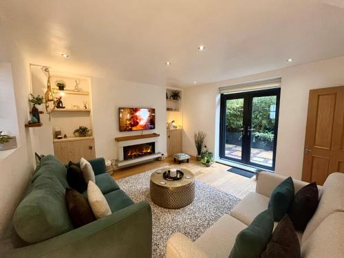 a living room with a couch and a tv at MC 2 bed central location - no parking in Stratford-upon-Avon