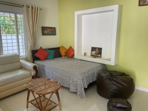 a living room with a bed and a couch at Varkala Beats - Traveller's Pad in Varkala