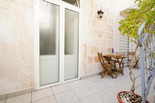 a patio with sliding glass doors and a table at Mati's in Monopoli
