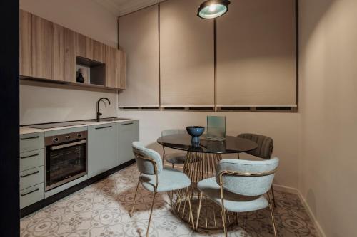 une cuisine avec une table, des chaises et des armoires dans l'établissement Ellul Living, à Il-Furjana