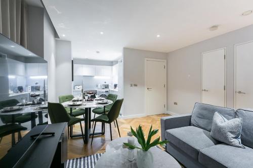 a living room with a couch and a table at Urban Chic - Camden in London