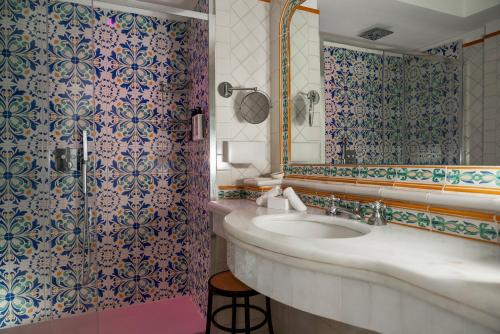 a bathroom with a sink and a shower at Hotel Eden Roc in Positano