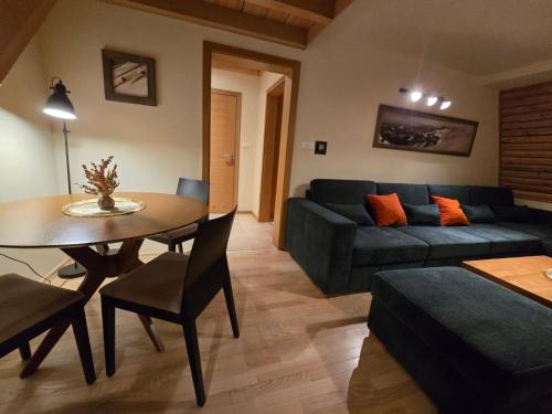 a living room with a couch and a table at Apartman 304 - Aparthotel Vucko in Jahorina