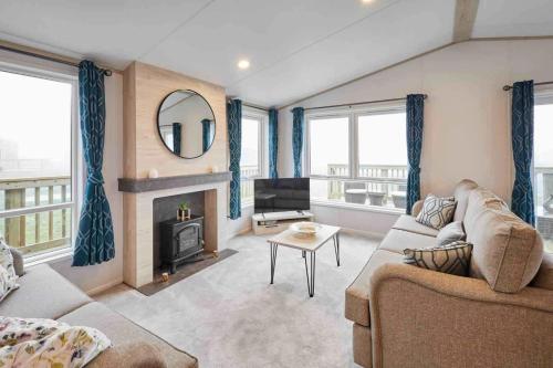 a living room with a couch and a fireplace at Host & Stay - Linden Lodge, Ashdown Retreat in Pickering