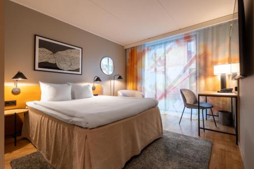 a hotel room with a bed and a large window at Hyatt Place Gothenburg Central in Gothenburg