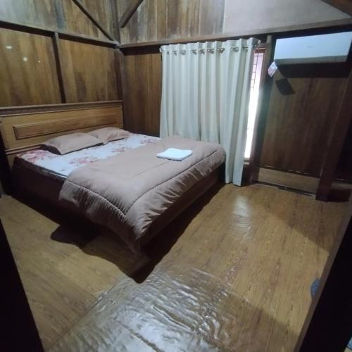 a bedroom with a bed with a laptop on it at Homestay Aceh House in Banda Aceh