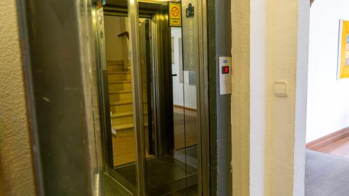 a row of glass doors in a hallway at SunDos Feria Valencia in Valencia