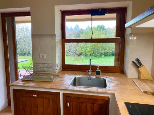 a kitchen with a sink and a window at Villa Le Fate - idromassaggio in Sambuco