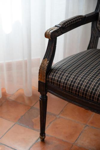 a chair with a checkered seat sitting on a floor at Hotel Eden Roc in Positano