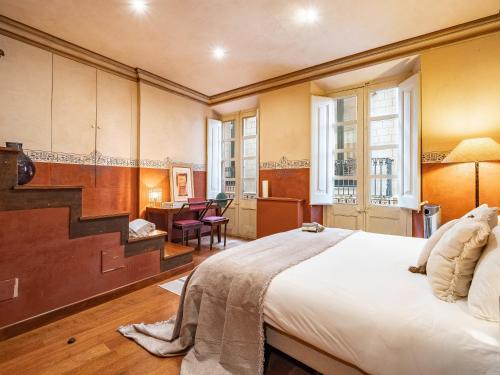 - une chambre avec un lit, un bureau et un escalier dans l'établissement Casa Indiana en el corazón de Begur, à Begur