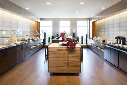 a large kitchen with a clock in the middle at AC Hotel by Marriott Madison Downtown in Madison