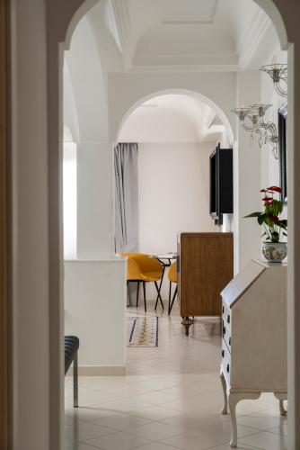 a living room with white walls and a table at Hotel Eden Roc in Positano