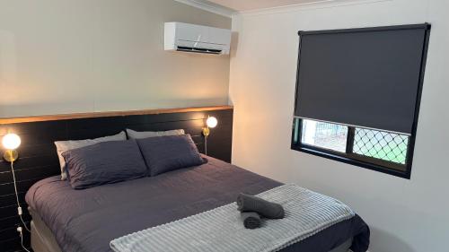 a bedroom with a bed and a window at Family retreat in Ningi Pet friendly in Sandstone Point