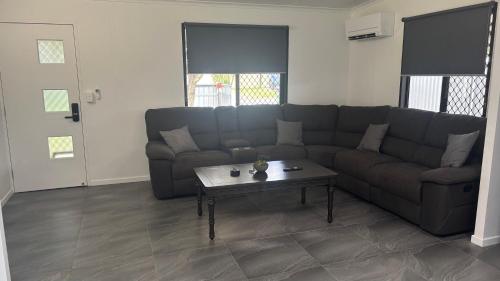 a living room with a couch and a coffee table at Family retreat in Ningi Pet friendly in Sandstone Point