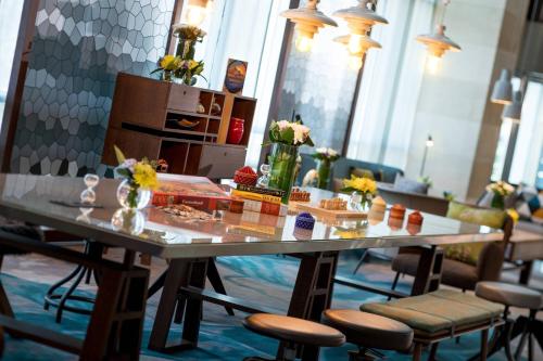 a table with flowers on it in a room with chairs at Renaissance by Crystall in Atyraū