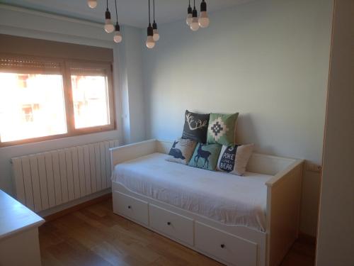 a bedroom with a bed with pillows on it at Los ojos del castillo in Soria