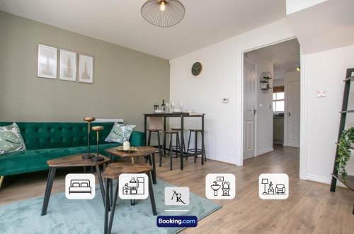 a living room with a green couch and tables at Cozy House By AR Properties Short Lets & Serviced Accommodation Colchester in Colchester