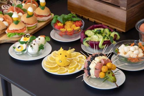 a table with many plates of food on it at Best Western Hotel Viterbo in Viterbo