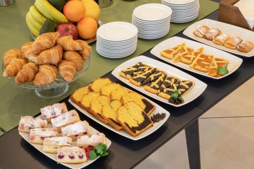 a table full of different types of bread and pastries at Best Western Hotel Viterbo in Viterbo