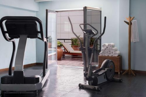 a gym with an exercise bike and a mirror at NH Mendoza Cordillera in Mendoza