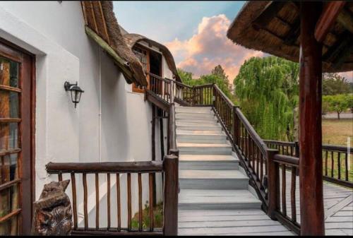 a wooden stairway leading to a building with a view at Ramkiki Country Restaurant and Conference Centre in Roodepoort
