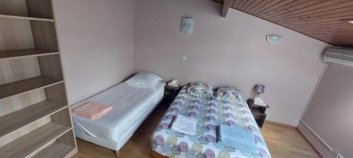 Cette petite chambre comprend 2 lits. dans l'établissement Maison Cosy avec jardin - Paris - 4 Pers -, à Aulnay-sous-Bois