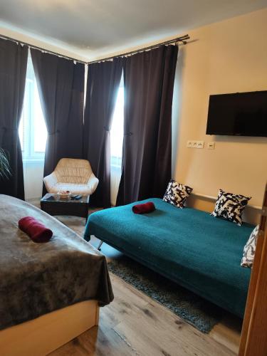 a hotel room with two beds and a chair at Veludo Apartments in Banská Bystrica