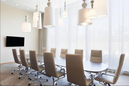 a dining room with a table and chairs at AC Hotel by Marriott Miami Aventura in Aventura