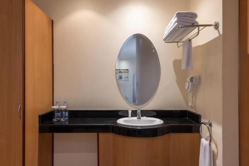 a bathroom with a sink and a mirror at Best Western Nairobi Upper Hill in Nairobi