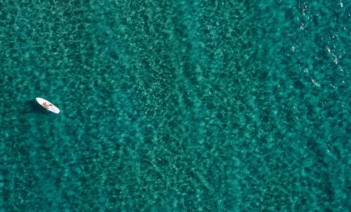 an overhead view of a boat in the ocean at Aneroussa Beach Hotel in Batsi