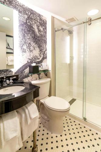 a bathroom with a toilet and a shower and a sink at Williamsburg Lodge, Autograph Collection in Williamsburg