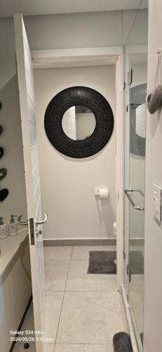 a bathroom with a mirror on the wall at No 2 Heleza Blvd Sibaya, Oceandune, Umhlanga Durban in Umdloti