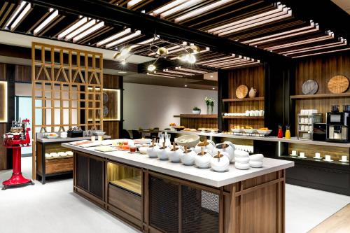 a kitchen with a large island with white dishes on it at AC Hotel by Marriott Bratislava Old Town in Bratislava