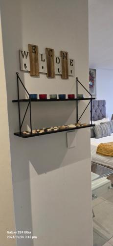 a shelf on a wall with different items on it at No 2 Heleza Blvd Sibaya, Oceandune, Umhlanga Durban in Umdloti