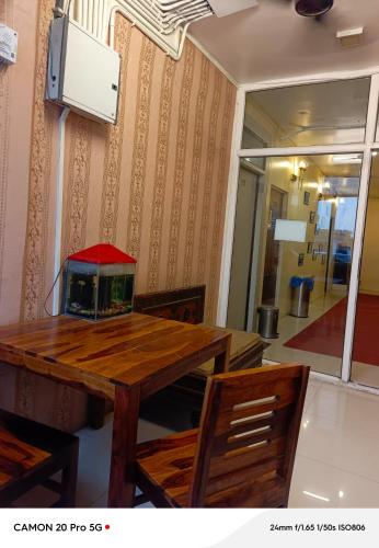 a table with a fish aquarium on top of it at Homestay Ac Dormitory in New Delhi