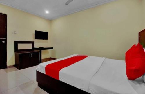 a bedroom with a bed and a television in it at Hotel happy rooms in Secunderabad