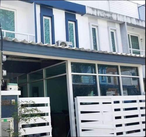 a building with a white fence in front of it at ทาวเฮ้าส์ทั้งหลังใกล้สนามบินดอนเมือง 15 นาที in Ban Wat Pho Thong