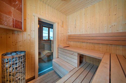 a wooden cabin with a sauna with a trash can at Špindl Lodge Apartments Self check-in & Sauna in Špindlerův Mlýn